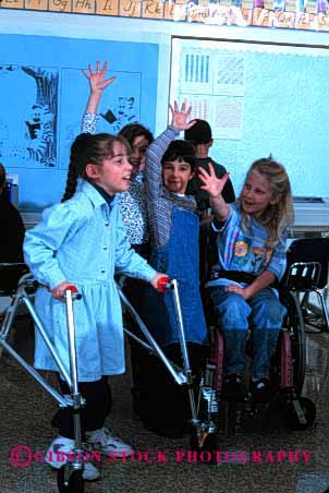 Stock Photo #2075: keywords - boy child children class classmate disability education elementary friend girl handicap interact learn model needs released school share social special team vert walker wheelchair