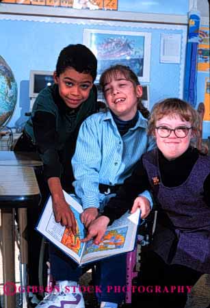 Stock Photo #2076: keywords - boy children class classmate disability education elementary ethnic friend gender girl handicap interact learn mix model released s school share social special team vert wheelchair