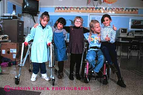 Stock Photo #2080: keywords -  affection child children class classmate disability down education elementary friend girl handicap horz interact learn model needs released school share social special syndrome team walk wheelchair