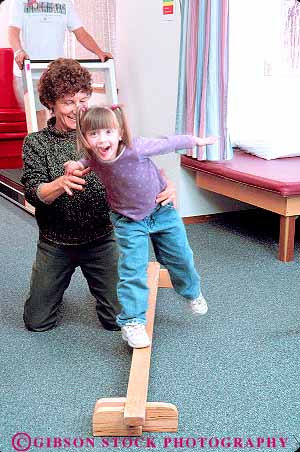Stock Photo #14644: keywords - assist assisting assists balance balancing career cerebral child children condition conditioning girl happy heal healer healing health healthy help helper helping helps hold holding holds job jobs mild palsy physical play recover recovery released smile smiling strengthen therapeutic therapist therapy vert with woman women work worker workers working works