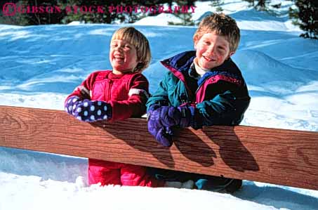 Stock Photo #3349: keywords -  boy children fence girl horz laugh outdoors play released smile snow winter