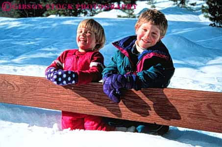 Stock Photo #3349: keywords - boy children fence girl horz laugh outdoors play released smile snow winter