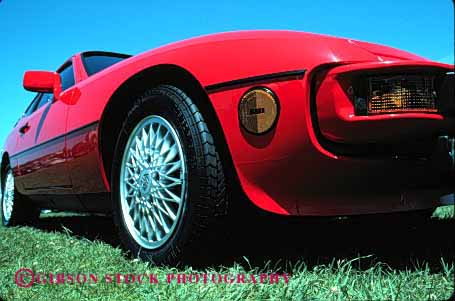 Stock Photo #2125: keywords - auto automobile car horz red sleek sports tire transpo vehicle wheel