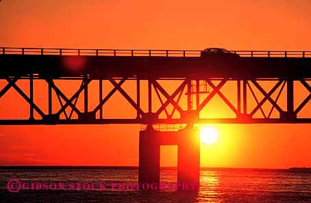 Stock Photo #2155: keywords -  auto bridge car drive dusk horz mackinac michigan moving orange road rural silouette street sunrise sunset transportation vehicle