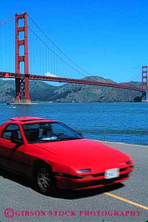 Stock Photo #2169: keywords -  auto bay bridge california car coast drive francisco gate golden highway moving ocean red road san scenic shore street transportation urban vehicle vert