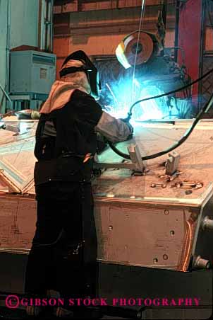 Stock Photo #2219: keywords - aluminum arc assemble bradley danger factory fighting hot job labor machine manufacture manufacturing metal military occupation power profession risk safety tool transport troop uniform vehicle vert war welder work