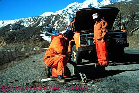 Stock Photo #2245: keywords -  bed geologists geology ground highway horz job men monitor mountains movement not orange released road slide slope snow stability team technician uniform winter work