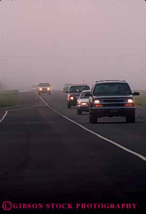 Stock Photo #2285: keywords -  car caution cloud commute congestion danger drive dusk fog headlight highway impaired in injury low moisture risk road safety slow street traffic transportation vehicle vert visibility weather
