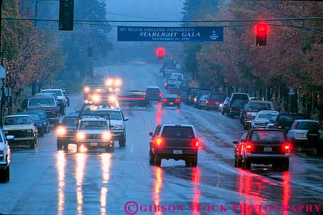 Stock Photo #18678: keywords -  auto autos brake braked braking bright california car cars caution climate dark evening glare headlights horz light lights main moisture mt pavement rain rains rainy red reflect reflecting reflection reflections reflects shasta signal slippery stop stopped street streets surface tail taillights town traffic water weather wet