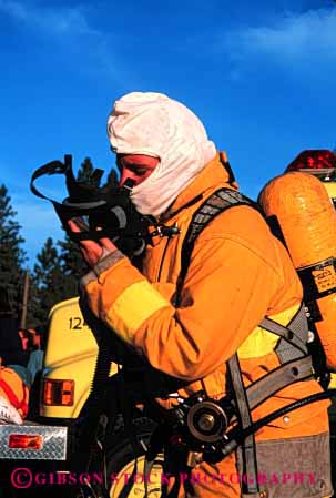 Stock Photo #2303: keywords - building burning career caution danger emergency fight fire fireman gear income job mask occupation oxygen protection public resistant risk safety service suit survive tank uniform vert vocation work yellow