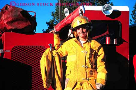 Stock Photo #2305: keywords -  building burning career caution danger emergency female fight fire firewoman horz income job male occupation public released risk role safety service suit truck uniform vocation woman work yellow young