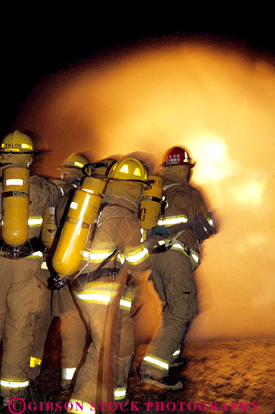 Stock Photo #2307: keywords - blur building burn burning career caution cooperate danger emergency fight fire firemen flame gas gear heat hot income job motion movement natural night occupation oxygen protective public resistant risk safety service suit tank team uniform vert vocation work