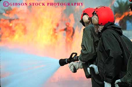 Stock Photo #2318: keywords -  burn cooperate danger  education emergency fire firemen flame gear heat horz hose hot injury learn navy practice protective risk suit team train training water