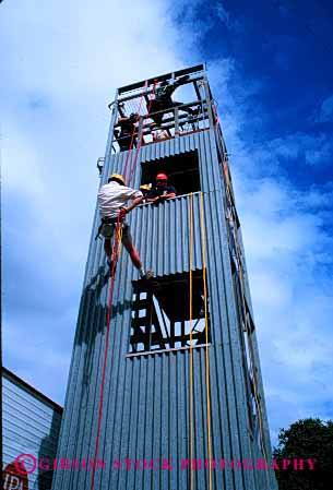 Stock Photo #2319: keywords -  burn class cooperate danger education emergency firemen injury learn practice repel rescue risk suit team tower train training vert