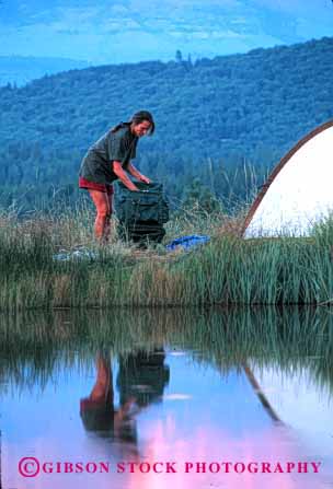 Stock Photo #2357: keywords -  alone backpack camping evening female lake outdoor private reflection relax released solitude summer tent vert warm water woman