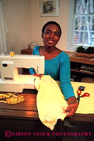 Stock Photo #2370: keywords -  african alone american black clothing create equipment ethnic female home indoor machine minority private relax released sew sewing skill vert woman