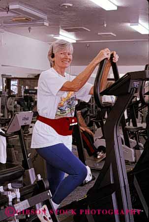 Stock Photo #2377: keywords -  conditioning elderly equipment exercise female fitness gym happy health mature old released senior sixties smile strength training trim vert woman workout