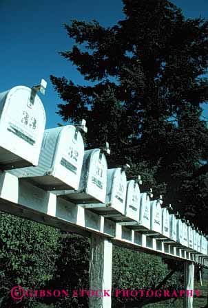 Stock Photo #2382: keywords -  box boxes communicate deliver group identical letter mail mailbox mailboxes office pattern post rail repeat row rural same sameness symmetrical vert white