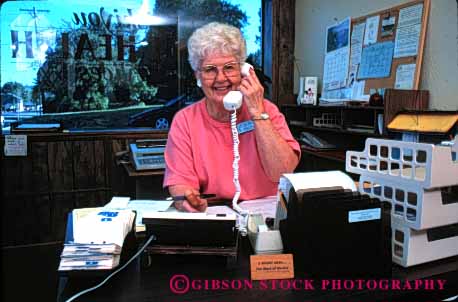 Stock Photo #2422: keywords -  business career commerce communicate desk elderly grandmother horz income job mature occupation office phone reception released senior smile talk telephone vocation volunteer woman work