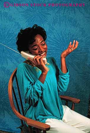 Stock Photo #2424: keywords -  african american black communicate cordless ethnic express female gesture minority phone released smile talk telephone turquoise vert woman