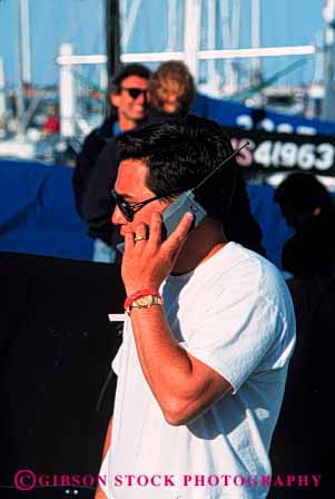 Stock Photo #2428: keywords -  boats business casual cell cellular commerce communicate convey data electronic field in man marina outdoor people person phone phones relax remote report sail talk talking talks technology telecommunication telephone telephones transfer use uses using vert work