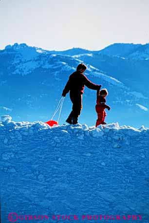 Stock Photo #3376: keywords -  affection cooperation daughter families fun mother outdoor play released sled snow sport together vert walk winter