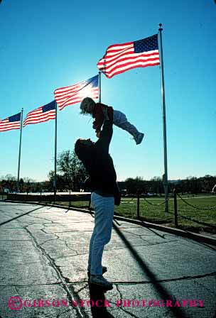 Stock Photo #2474: keywords -  baby carry child daughter dc family female flags girl joy lift monument mother parent play released silhouette single sun together up vert washington wife woman