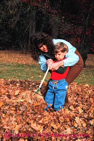 Stock Photo #2484: keywords -  autumn boy child chore fall family female intimate leaf learn leaves mother parent practice rake released single son teach together vert wife woman