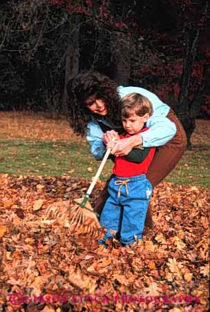 Stock Photo #2484: keywords - autumn boy child chore fall family female intimate leaf learn leaves mother parent practice rake released single son teach together vert wife woman