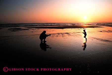 Stock Photo #2493: keywords -  beach child family female horz mother ocean parent play recreation released run silhouette single summer sunrise sunset together vacation warm water wife woman