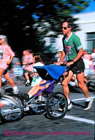 Stock Photo #2498: keywords -  action blur boy child dad daughter father foot girl motion not outdoor parent push race released roll run running single son speed sport stroller together vert wheel