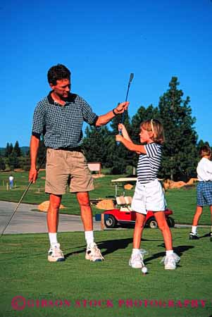 Stock Photo #2504: keywords - child dad daughter father girl golf help learn outdoor parent practice released single sport summer teach together vert