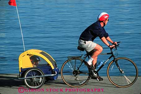 Stock Photo #2512: keywords -  bicycle bike boy child dad father girl horz not outdoor parent pull released single son sport summer team together trailer