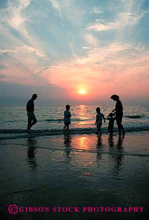 Stock Photo #2515: keywords -  beach children dusk family ocean parent released summer sun sunset vacation vert wade warm water