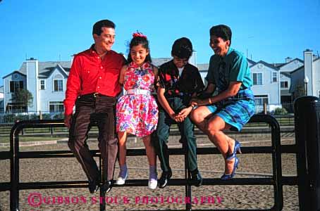 Stock Photo #2520: keywords - children daughter ethnic families family father group happy hispanic horz laugh mexican minority mother parent portrait released sit son together