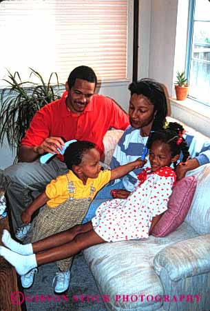 Stock Photo #2526: keywords -  african american black children comb daughter ethnic family father group hair happy home house minority mother parent released son together vert