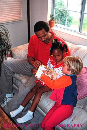 Stock Photo #2527: keywords -  african american black book children daughter ethnic father friend girls group happy home house minority mixed parent play read released share single together vert