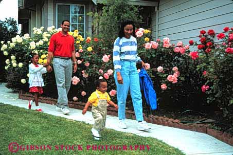 Stock Photo #2531: keywords - african american away black children daughter ethnic family father group happy home horz house minority mother parent released son together walk yard
