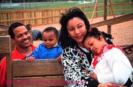 Stock Photo #2534: keywords - african american black children daughter ethnic family father ground group happy horz minority mother parent play relax released son summer together