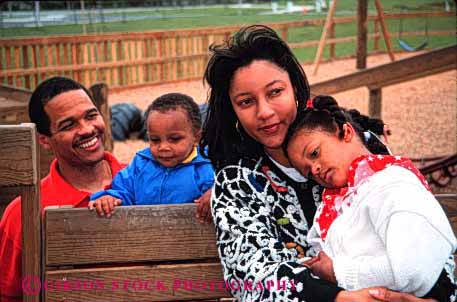 Stock Photo #2534: keywords -  african american black children daughter ethnic family father ground group happy horz minority mother parent play relax released son summer together