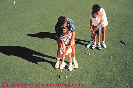 Stock Photo #3372: keywords -  boy brother child cooperate daughter families family father game girl golf horz learn mother outdoor released sister sport summer teach