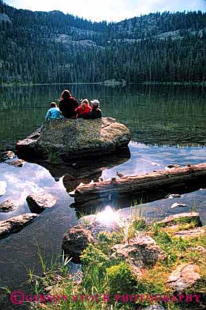 Stock Photo #2545: keywords -  calm child children family father lake mother mountain parent peaceful quiet recreation reflection released rock sit solitude summer sun together vert water wilderness