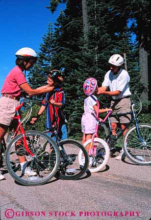 Stock Photo #2547: keywords -  bicycle bike biking check child children daughter exercise family father helmet mother parent recreation released safety son sport summer together vert