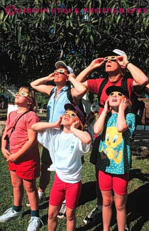 Stock Photo #2548: keywords -  child children eclipse family father filter funny glasses humor light mother parent recreation released solar sunlight together vert view vision