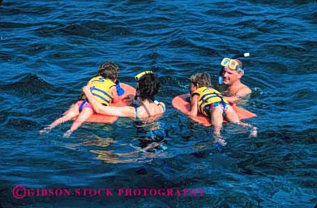 Stock Photo #2554: keywords -  child children family father float horz mother ocean parent play recreation released safety snorkel swim together tropical vacation vest water