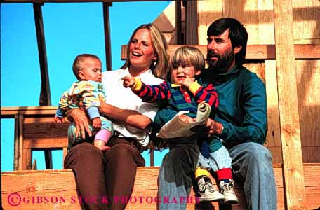 Stock Photo #2556: keywords - baby build child children construction family father frame home horz house inspect job mother new parent released sit together wood