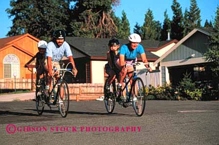 Stock Photo #2561: keywords -  bicycle bicycling bike child children couple exercise family father horz mother neighborhood parent recreation released ride roll sport street tandem together twin two