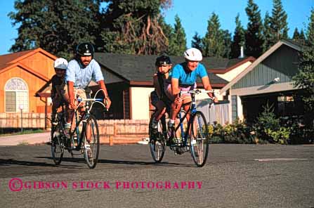 Stock Photo #2561: keywords - bicycle bicycling bike child children couple exercise family father horz mother neighborhood parent recreation released ride roll sport street tandem together twin two