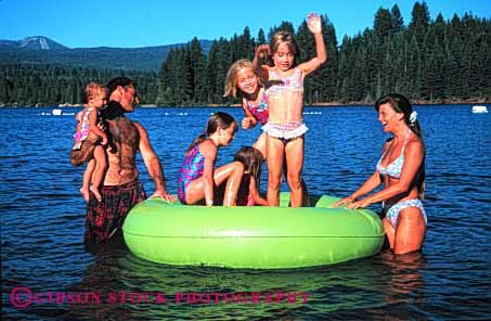 Stock Photo #2562: keywords -  child children family father float girl horz lake mother parent play recreation released summer together vacation warm water