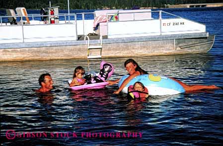 Stock Photo #2563: keywords -  boat child children family father float girl horz mother parent patio play recreation released summer swim together vacation warm water